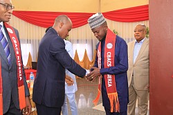 An inductee in a handshake with the Pioneer President during of the college during the second Annual Conference held in the Rafia City of Ikot Ekpene, Nigeria