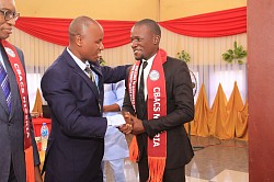 Mr. President in a handshake with a new member of college during the 2nd Annual Conference and Induction of New Members held in the Rafia City of Ikot Ekpene